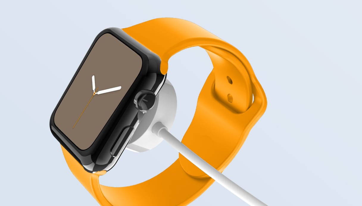 Een Apple Watch met oranje band aan een draadloze oplader.