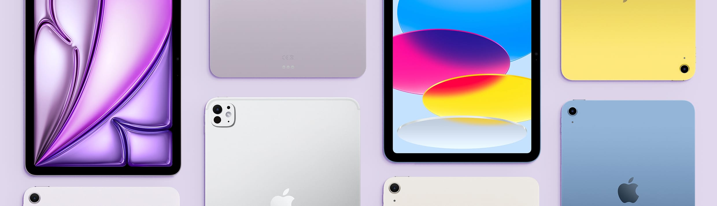 Afbeelding met verschillende iPads op een lila achtergrond.